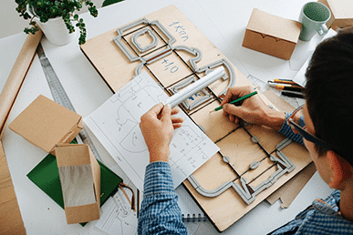 a man planning out the layout for a package